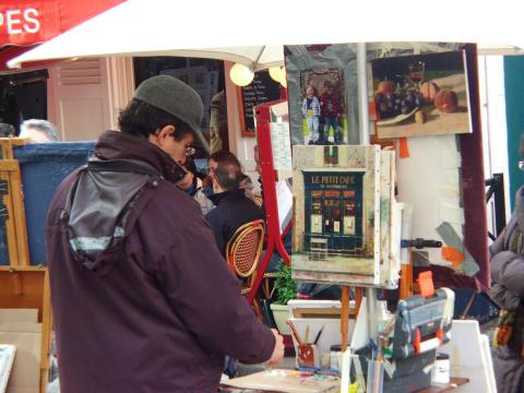 image Artista trabajando en un mercadillo de arte, París