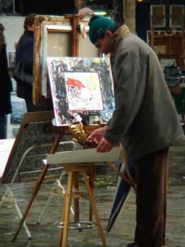 image Artista trabajando en un mercadillo de arte, París