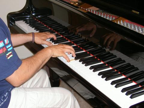 image Manos de un joven tocando el piano